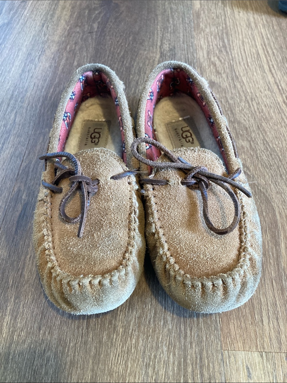 UGG Kids Chestnut Brown Suede Moccasin Slippers with tiger print liner.